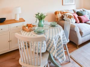 a living room with a table with chairs and a couch at The Barn in Cantley