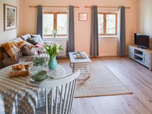 a living room with a table and a couch at The Barn in Cantley +12 photos
