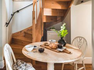 a wooden table with a plate of food on it at The Nook - Uk44735 in Tallentire