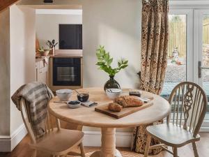 a table with a plate of food on it in a kitchen at The Nook - Uk44735 in Tallentire