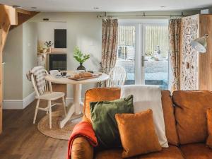 a living room with a couch and a table at The Nook - Uk44735 in Tallentire