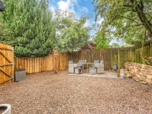 a backyard with a fence and chairs and a table at The Nook - Uk44735 in Tallentire +14 photos