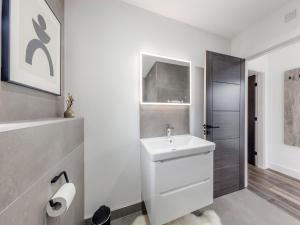 a white bathroom with a sink and a shower at Cadnant Lodge 2 - Uk42795 in Llangefni +4 photos