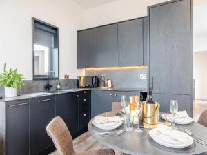 a kitchen with a table and chairs in a kitchen at Cadnant Lodge 2 - Uk42795 in Llangefni