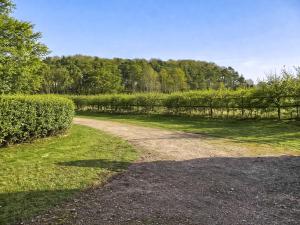 a dirt road in a field with a fence at South Barn in Heydon +27 photos