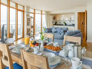 a dining room with a table with food on it at Apartment 22, Horizon View in Westward Ho