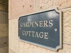 a sign on a wall with the words gardeners cottage at Gardeners- Uk7233 in Kirkmichael