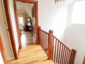 a hallway with a wooden stairway in a home at Gardeners- Uk7233 in Kirkmichael