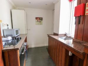 a kitchen with a counter top and a microwave at Gardeners- Uk7233 in Kirkmichael
