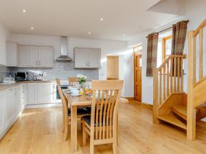 a kitchen with a wooden table and chairs at The Old Laundry - Uk12136 in Hewelsfield