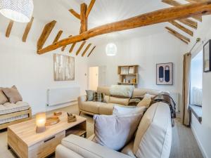 a living room with a couch and a table at The Retreat in Sudbrooke