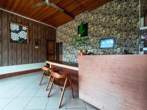 a bar in a restaurant with two chairs and a counter at The Lavana Green Asri Cottage in Senggigi