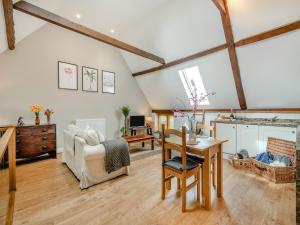 a living room with a table and a chair at The Cartlodge - Ukc1039 in Hickling