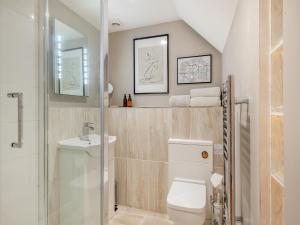 a bathroom with a toilet and a sink at The Cartlodge - Ukc1039 in Hickling