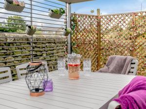 a white table with a drink on a patio at Alton Hall Cottage in Ashover
