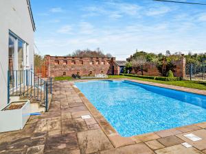 a swimming pool in the backyard of a house at Pengethley Manor - Uk39045 in Peterstow