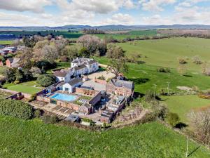 an aerial view of a house with a swimming pool at Pengethley Manor - Uk39045 in Peterstow