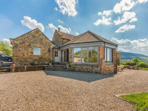 a brick house with a gravel driveway at The Gin Gang in Whorlton +17 photos