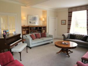a living room with a couch and a piano at Cray House - Ukc4632 in Glenshee
