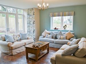 a living room with two couches and a table at Salar's Rest - 28028 in Alnmouth