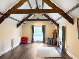 a living room with wooden floors and a large window at Ember Sky Yurt - Uk51679 in Beadnell