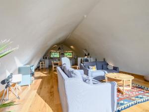 a living room with blue chairs and a table at Jack Strawbale House - Uk7521 in Strontian