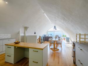 a kitchen and dining room with an archway in the ceiling at Jack Strawbale House - Uk7521 in Strontian