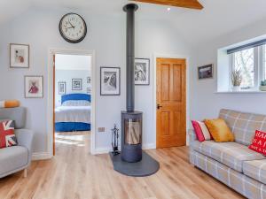 a living room with a wood burning stove in it at The Lodge At Edenbridge in Shepton Mallet