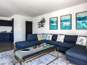 a living room with a blue couch and a table at Seaglass in Mortehoe +34 photos