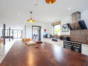 a large kitchen with a large wooden counter top at The Grain Dryer in Gloucester