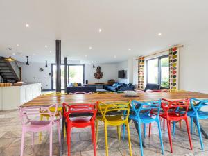 a room with a large wooden table with colorful chairs at The Grain Dryer in Gloucester +26 photos