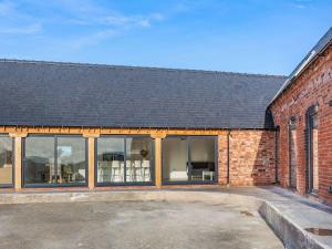 an external view of a brick building with large windows at Buckley Farm, Barn 1 - Uk36588 in Oswestry