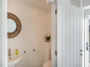 a bathroom with a sink and a toilet and a mirror at Buckley Farm, Barn 1 - Uk36588 in Oswestry
