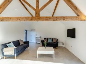 a living room with two couches and a tv at Buckley Farm, Barn 1 - Uk36588 in Oswestry