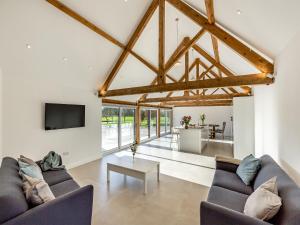 a living room with two couches and a tv at Buckley Farm, Barn 1 - Uk36588 in Oswestry +20 photos