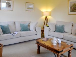 a living room with two couches and a coffee table at Islabank Farmhouse - Saap in Kirkton of Airlie