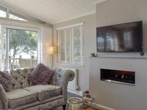 a living room with a couch and a fireplace at Seacliff in Corton