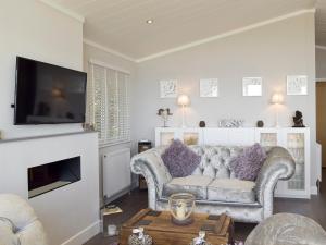 a living room with a couch and a tv at Seacliff in Corton