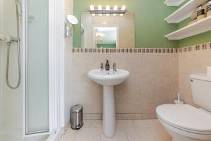a bathroom with a sink and a toilet and a mirror at Seaview Bed & Breakfast in Isle of Lewis +30 photos