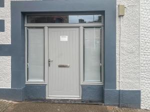 a door of a building with a sign on it at The Embassy in Eyemouth