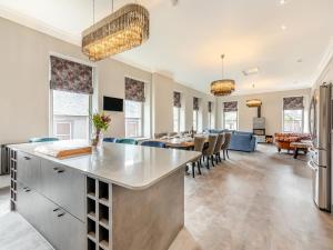 a kitchen and living room with a table and chairs at The Embassy in Eyemouth