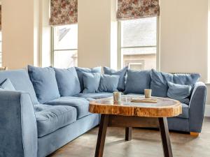 a blue couch in a living room with a coffee table at The Embassy in Eyemouth +21 photos