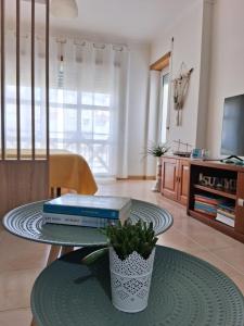 a living room with a table with books on it at Filipe´s House in Baleal