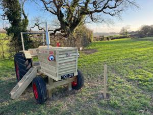 a wooden cart sitting in the middle of a field at Lakeview Lodge- Uk40692 in Crowhurst