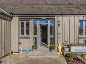 a house with sliding glass doors on it at Orchard Barn in Thurlton