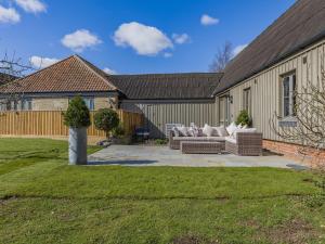 a patio with two couches in a yard at Orchard Barn in Thurlton