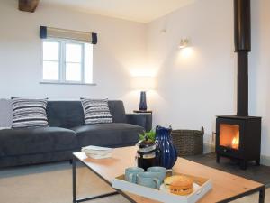 a living room with a couch and a coffee table at The Dairy - Uk34564 in Whitchurch