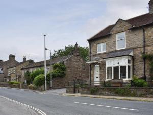 a row of brick houses on the side of a street at Arkle Terrace in Reeth