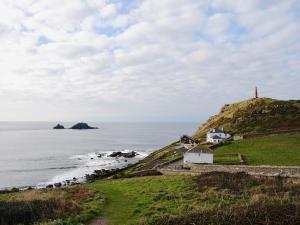 a house on a hill next to the ocean at Bowji in St. Just