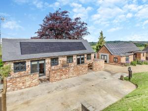 a home with solar panels on the roof at The Old Stables 1 - Uk46682 in Shipton under Wychwood